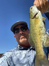 Cut shad anchored fishing different debts. Catch a couple then move. Water  is muddy 64 degrees. 23 total in just a few hours.