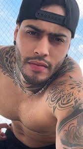 Showcasing Muscles and Tattoos: A Striking Visual Experience