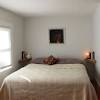 Navy blue bedroom with stylish pink nightstand. 3