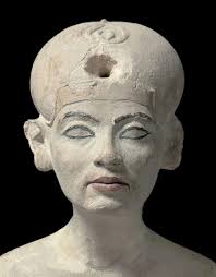 A close-up of a small, painted Egyptian statue of a woman, likely Queen  Nefertiti, based