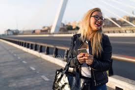 Cheerful young blonde lady with casual hairstyle pulling her hair and biting underlip. Chinese Blonde Hair Woman In Barcelona Longhair Stylish Stock Photo 212427844