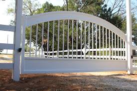 A slim wrought iron fence surrounding a lush and verdant garden. Color Psychology And Your Gate Aberdeen Gate