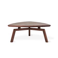 A coffee table is the focus of any living room furniture layout and creates the perfect spot for entertaining. Gus Solana Triangular Coffee Table Schreiters