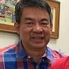 Senator manny pacquiao is sitting in the second row of a black government escalade, his left foot on the center console, a 9 mm handgun in the seatback in front of him. 1