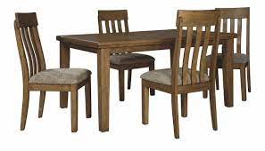 The dining table is where friends and family can gather to share a meal or a cup of coffee. The Flaybern Dining Room 5 Pc Set Rectangular Butterfly Table With 4 Upholstered Side Chairs Sold At Bailey S Furniture Serving Dallas Tx And Surrounding Areas