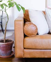 Paint the seams and piping of the leather sofa with the leather dye on a paintbrush. How To Choose And Care For Leather Furniture Articulate