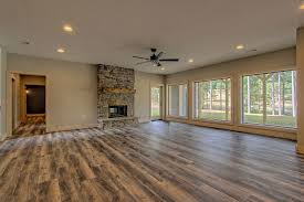 Great Room Features A Stacked Stone Fireplace Double Sided With A Sawn Timber Mantel And Lvp Floors Walk Out Basemen Custom Homes Great Rooms Craftsman House