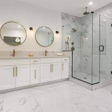 The white cabinets, walls, and subway tile backsplash keep the room feeling bright and open while the wood floor warms up the atmosphere with reflected light. Bathroom Remodeling By Design Soul Utions