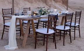 Dark Mahogany Tiffany Chairs With Rustic Timber Trestle Table For A Gorgeous Intimate Beach Wedding Furniture Hire Tiffany Chair Wedding Furniture