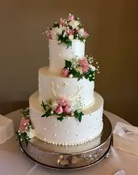 Duel Design Buttercream Wedding Cake With Scroll Work And Pearl Dots Garnished With White Romantic Wedding Cake Buttercream Wedding Cake Floral Wedding Cakes