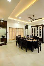Wooden coffee table (finish colors: Dining Room With Wooden Table And Chair And False Ceiling By Monnaie Architects
