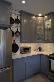 Keeping the existing maple flooring, the blend of white and cherry cabinets brings a classic. Lakeview Kitchen Bella Casa Interiors