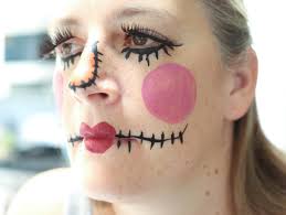 Her face is painted to look like a sack like you would see on a scary scarecrow and the artist has added patches, stitches and more. Diy Scarecrow Costume Fun365