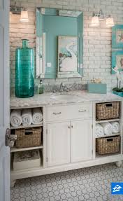 Soften Up An Industrial Looking Bathroom With Cozy Touches Like Wicker Baskets And Distressed Paintings Beach Bathrooms Beach House Bathroom Beachy Bathroom