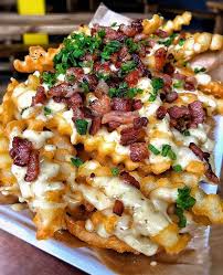 Some Delicious Looking Fries Topped With Cheese Bacon And Spring Onions In 2020 Extreme Food Recipes Travel Food