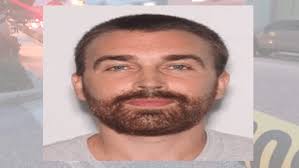 Man wanted for crash into park gate was last seen jumping into lake