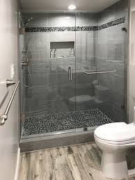 Floor to ceiling herringbone subway tile shower with tiled diagonal bench pebble niche inlay and pebble floor. Pebble Tile Flooring Tilehub
