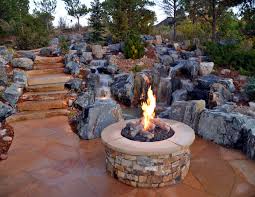 You'll enjoy the soft sound of trickling water as the flame burns brightly in the center of the bowl. Stone Fire Pit With Naturalistic Water Feature In Parker Landscaping In Denver