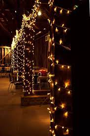 Looking Down The Barn Fairy Lights Wound Around The Pillars For Wedding Sparkle Wedding Lights Fairy Lights Wedding Pavilion Wedding Reception