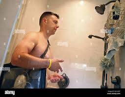 At his home in Plymouth, Minnesota, Peter Quimby must waterproof the  batteries and control unit that run his left ventricular assist device,  LVAD while he showers, July 10, 2013. He is on