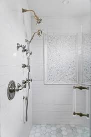 A Chrome Shower Kit Is Mounted To White Subway Backsplash Tiles Over Marble Hex Floor Tiles W Window In Shower Bathroom Renovations Minimalist Bathroom Design