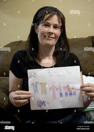 Angel Cook holds a drawing one of her children gave her when the children  were in foster homes on Oct. 30, 2014 at their home in Cleburne, Texas. The  Cook family was