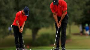 Tiger woods watches as his son charlie sinks a putt on the first green. Tiger Woods Golfing Great Finished Seven In A Tournament With His Son Charlie
