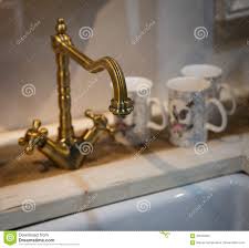 vintage brass kitchen faucet stock