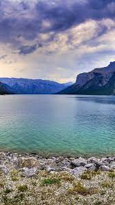 19 rocky mountains hd wallpapers and background images. Rocky Mountain Lake Stones Sky Clouds Dusk 750x1334 Iphone 8 7 6 6s Wallpaper Background Picture Image