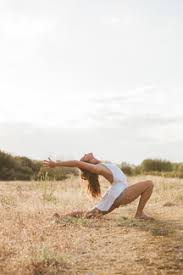 This position is the perfect yoga pose for constipation because it stretches your entire body and releases tension. Boho Woman In High Crescent Lunge Yoga Pose In Sunny Rural Field Stockphoto