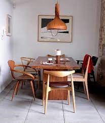 Furniture Mixed Midcentury Chairs Remodelista Mixed Dining Chairs Dining Room Inspiration Woven Dining Chairs