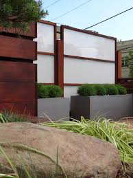 Speaking of greenery, this modern horizontal fence has ivy growing on it and trees growing in front to break up the fence and to make the fence appear to be a part of the garden/organic. 12 Picture Perfect Fences We Re Loving Right Now Hgtv S Decorating Design Blog Hgtv