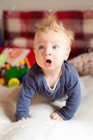Delicate looks with long luxurious curls or unique braided elements are the exclusive. Close Up Of Cute Little Baby Boy With Spiky Blonde Hair Crawling On Bed Stock Photo Picture And Royalty Free Image Image 65649840