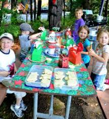 Group of young friends having fun at a new year`s eve outdoor pool party, dancing and holding cardboard. 150 Christmas In July Party Ideas Christmas In July July Party Christmas