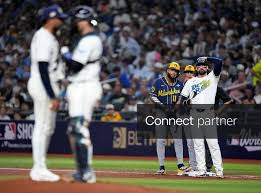 Licensable picture: Milwaukee Brewers first base coach Spencer Allen speaks to Milwaukee Brewers left fielder Jackson Chourio (11) as Tampa Bay Rays