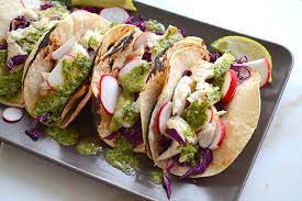 Assemble the tacos by laying 2 tortilla down, adding some cabbage, 1/4 of the fish, a few slices of radishes, top with some chimichurri. 15 Minute Fish Tacos With Chimichurri Sauce I Am A Honey Bee