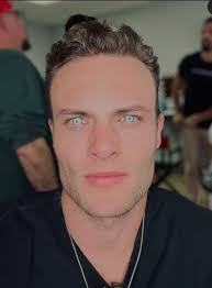 To me, he gives off serious Alpha energy. A man of few words.