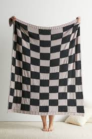 The funky print is bold but can mesh well with your existing wardrobe. Stargazer Checkerboard Knit Throw Blanket Urban Outfitters