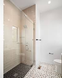 By keeping the walls and the vanity simple and neutral, the designer is able to experiment with the shower and floor tiles and create a load of visual interest with this starburst pattern. Russo Residential S Modern Day Gatsby Home The Tile Shop Blog In 2021 Bathroom Tile Designs The Tile Shop Bathroom Trends