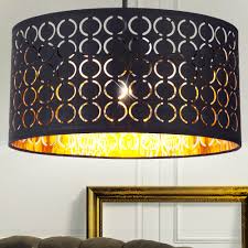 A gold and black scheme give this room a sophisticated, glamorous look. Textile Hanging Lamp In Black Gold For The Living Room Clarke Meinelampe