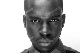 Close up black and white of young black man staring Stock Photo by  mimagephotography
