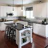 A hutch and wall cabinets have crown tops. 1