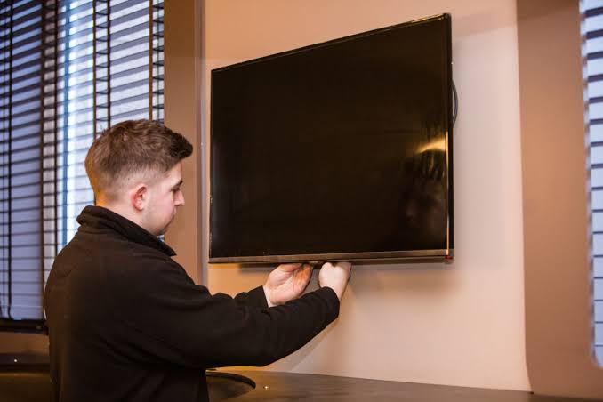 Chislehurst engineer ready to mount TV with drill and level