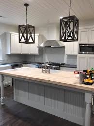 White Kitchen Cabinets With Black Counters And A Large Center Island W White Kitchen Cabinets White Kitchen Remodeling Butcher Block Countertops White Cabinets