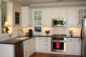 Contemporary craftsman style kitchen with black wood cabinets on a light wood floor. Small White Kitchen With Black Countertops Novocom Top