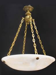 The alabaster shades an astonishing glowing effect when lights are on. A Very Fine Gilt Bronze And Hand Carved Alabaster Pendant 4 Lights Maurice Chandelier Inc