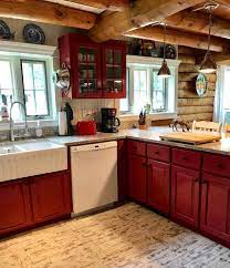 Abbey and phil hendrickson transformed their kitchen by painting the cabinets in forest canopy, a deep, deep green valspar paint, and a white from home depot (specifics since forgotten). Log Cabin Kitchen With Red Painted Wood Cabinets So Charming Log Cabin Kitchens Cabin Kitchens Log Home Kitchens