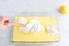 To make glaze, gradually add hot milk and yellow food coloring to confenctioners' sugar in a bowl, blending well. Lemon Cream Cheese Pudding Dessert Amanda S Cookin One Pan