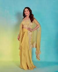 Madhuri Dixit Nenes cape + drape skirt set proves why yellow is a wedding  wardrobe must-have | Vogue India | Wedding Wardrobe