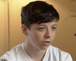 Petty criminal, 40, who has spent more than 12 years behind bars for  stealing a mobile phone hugs his son, 14, as they are reunited for the  first time since he was